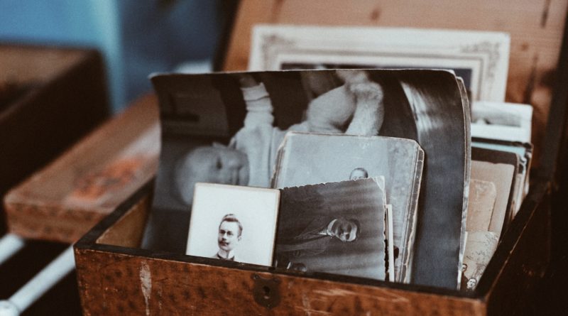 old photos in brown wooden chest